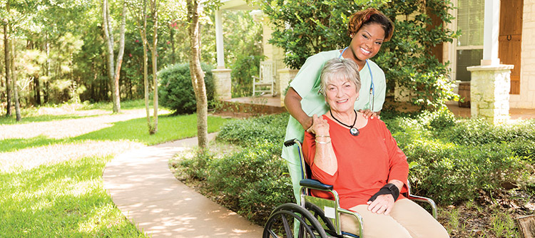 A caregiver and her patient outside
